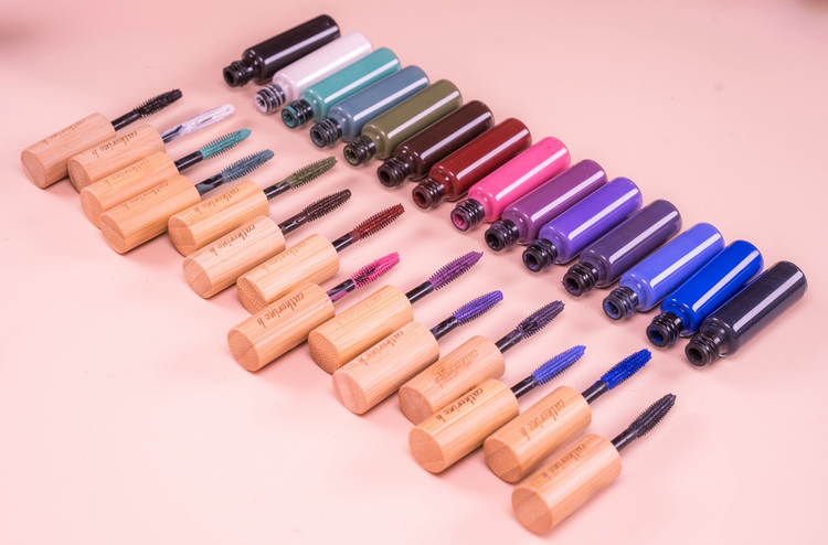 two mascara bottles on white background. One open with the brush showing.
