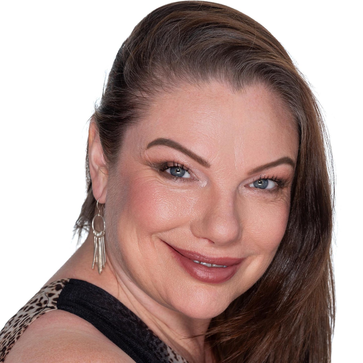 brunette ob white background wearing captivate lipstick, radiant foundation , walnut eyebrows and resilience blush