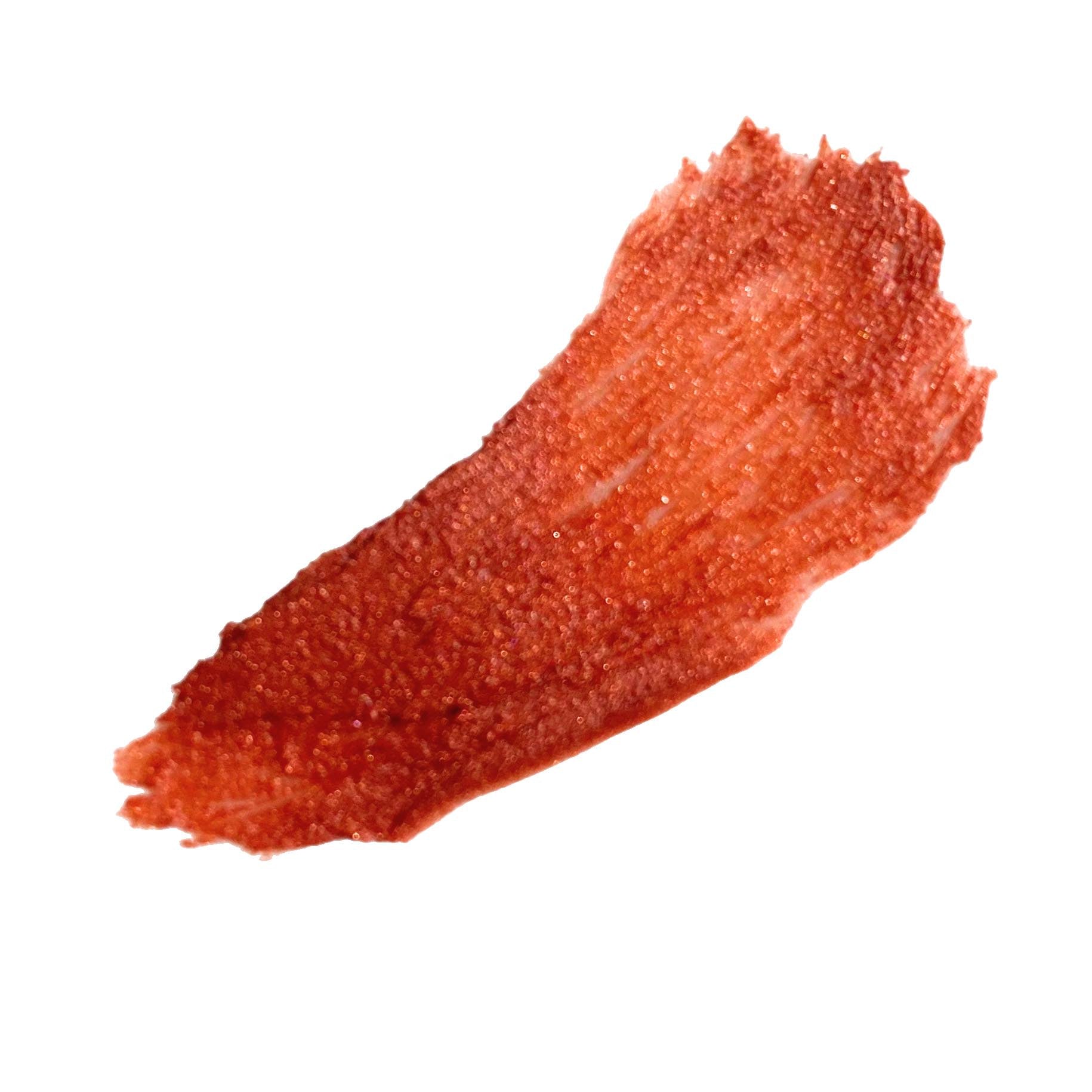 orange bronze tinted lip balm smear on white back ground