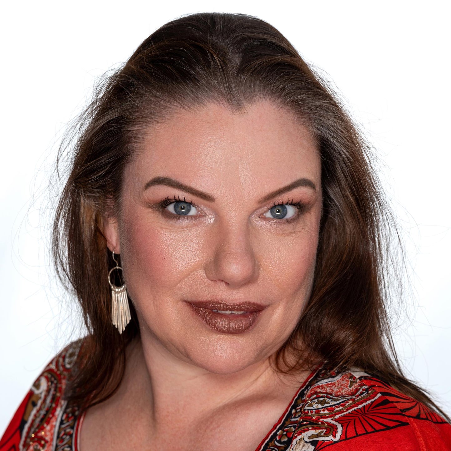 brunette on white back ground wearing golden brown cocoa glow lipstick