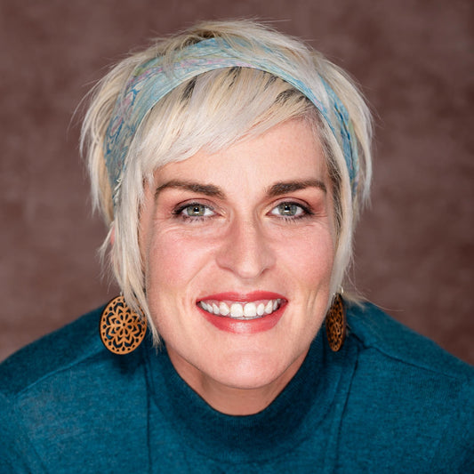 blond mid range skin tone brown background  wearing Dusk - Warm Dusky Orange Pink Organic Lipstick