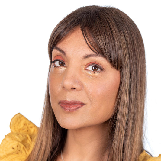 Brunette with light south asian skin tone on white background wearing dark brown espresso eyebrow pomade