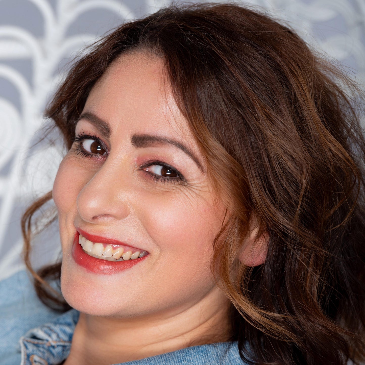 brunette wearing Flourish - Shimmery Orange Brown Deep Coral Long Lasting Organic Lipstick