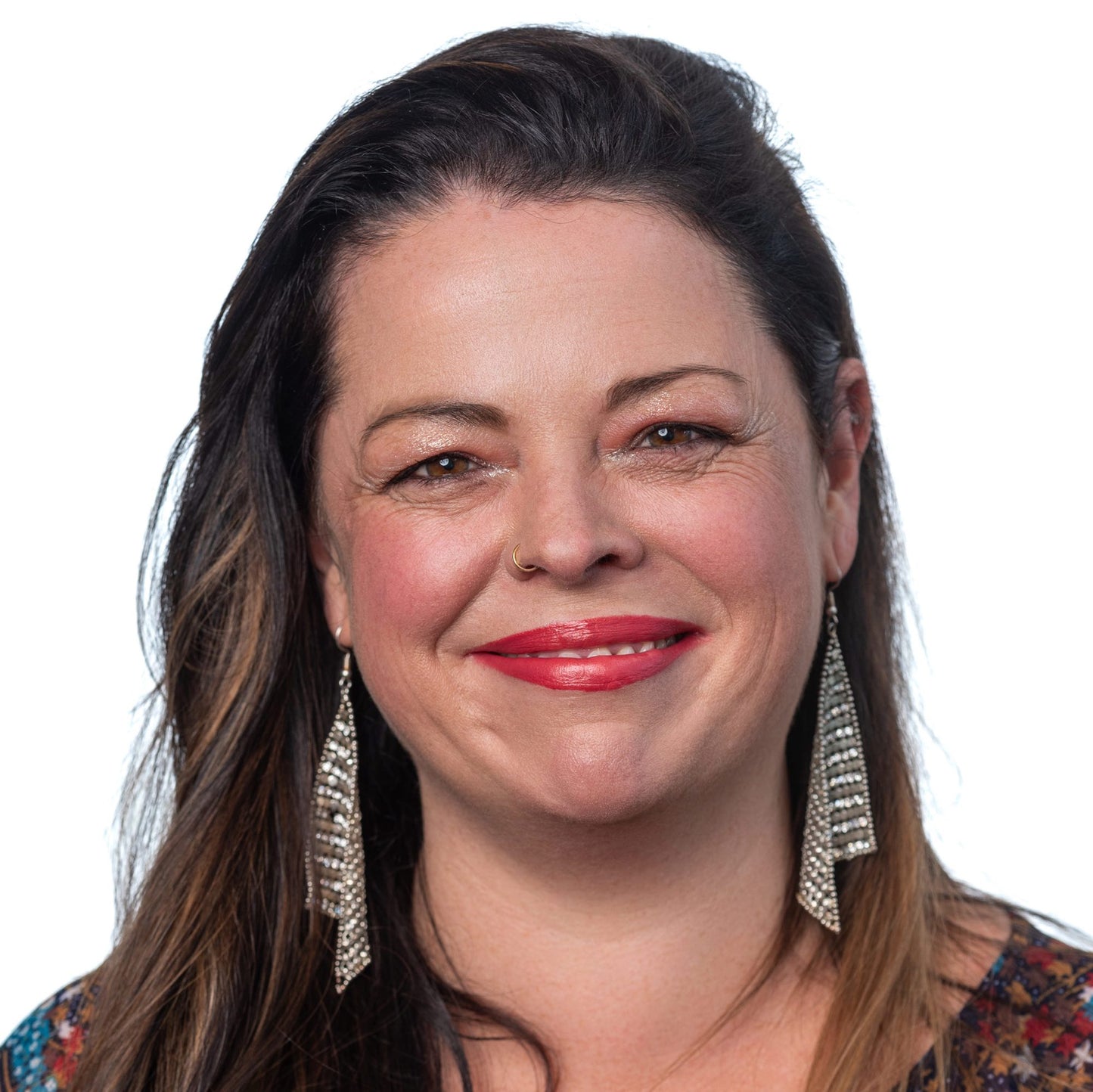 woman with long brown hari and brown eyes on whot background wearing ravishing foundation and berry kissable lipstick