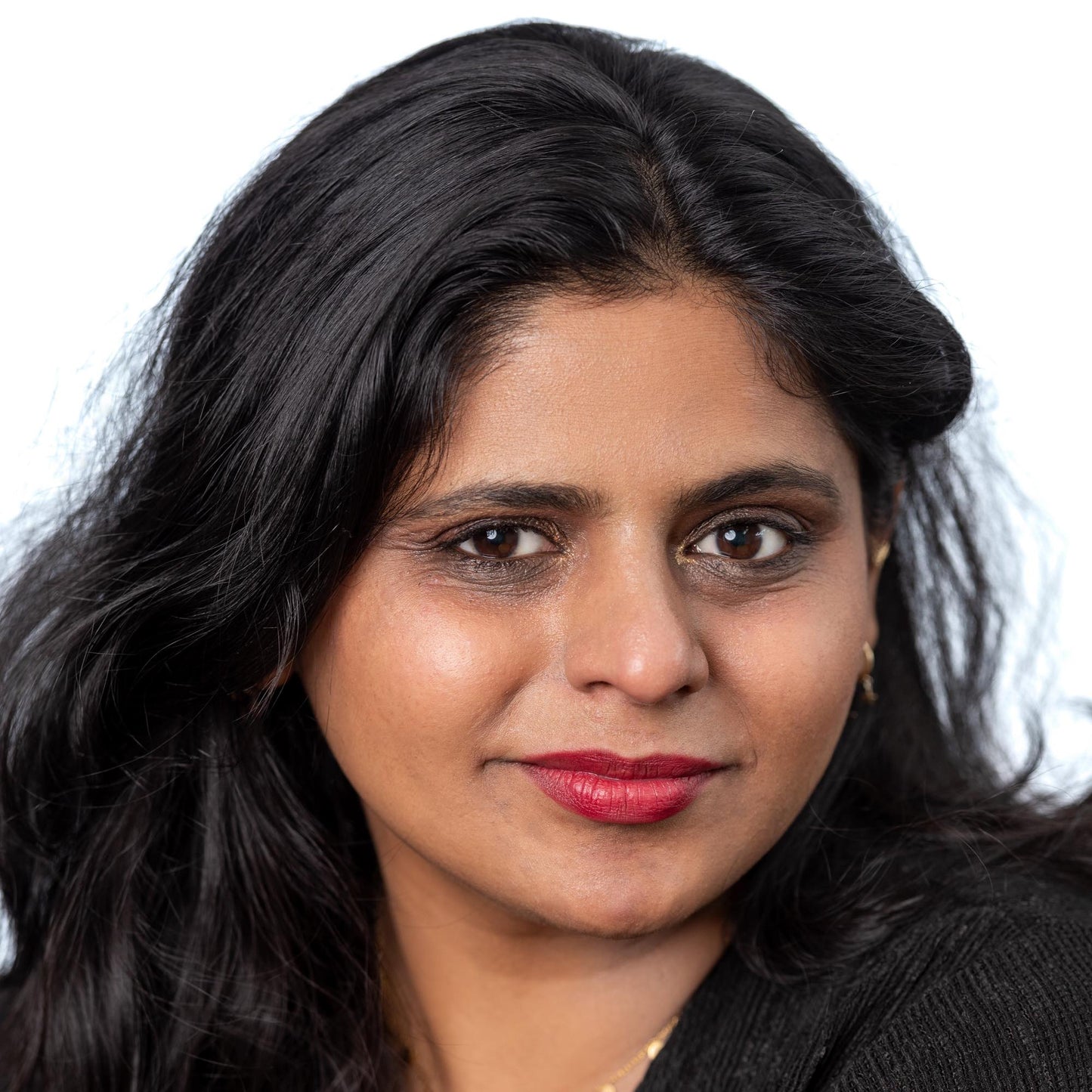 Indian woman on white back ground wearing tango lipstick, divine foundation and coal eyebrow pomade