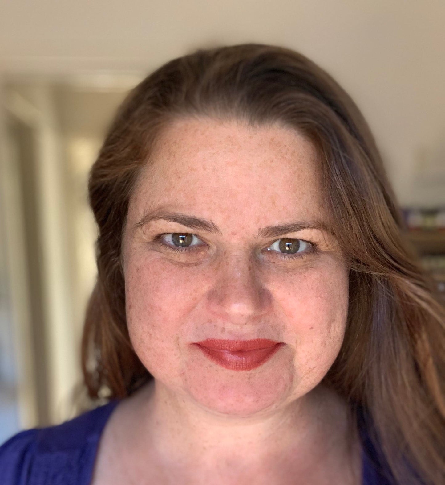brunette wearing Flourish - Shimmery Orange Brown Deep Coral Long Lasting Organic Lipstick