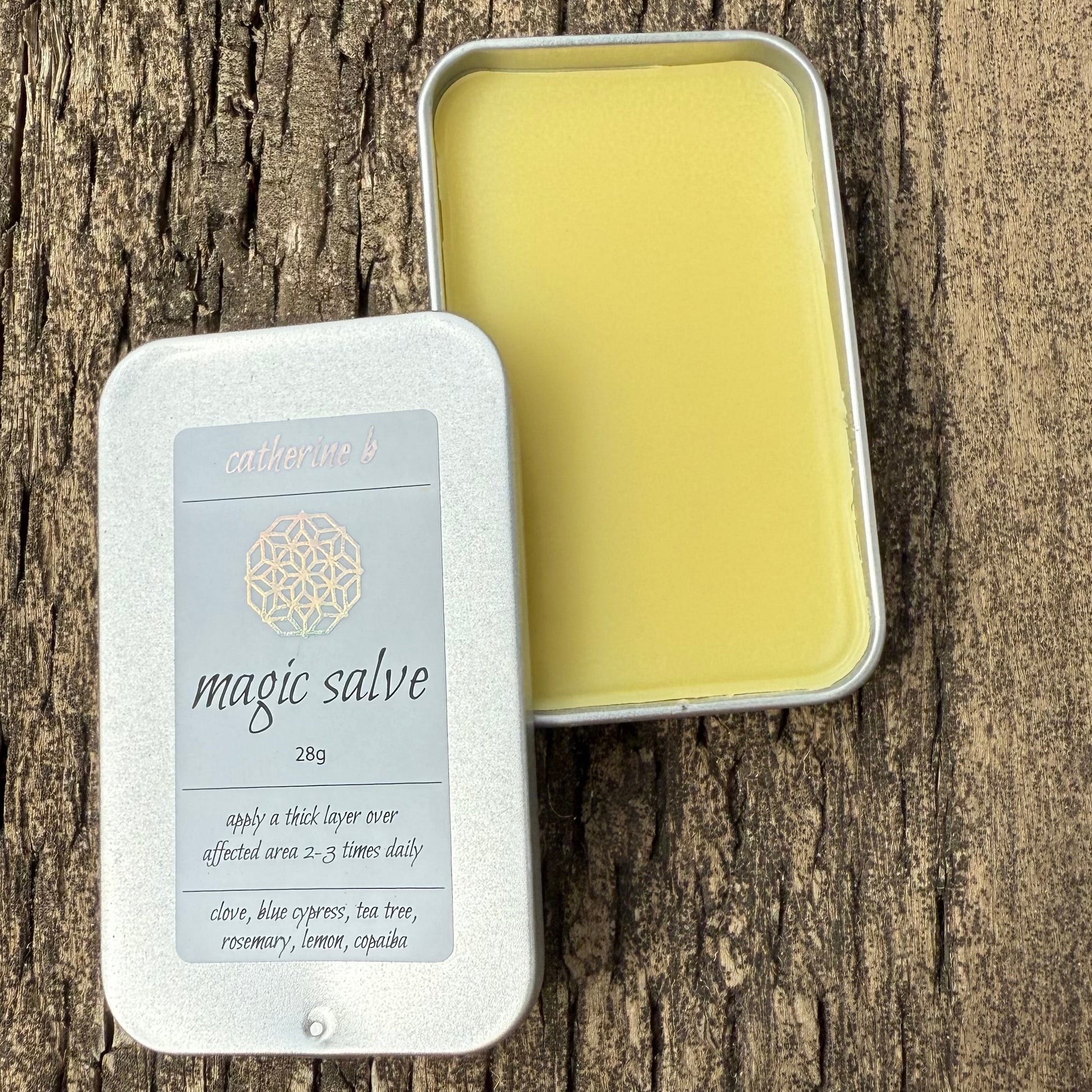 Large tin of 'magic salve’  28g on a wooden surface