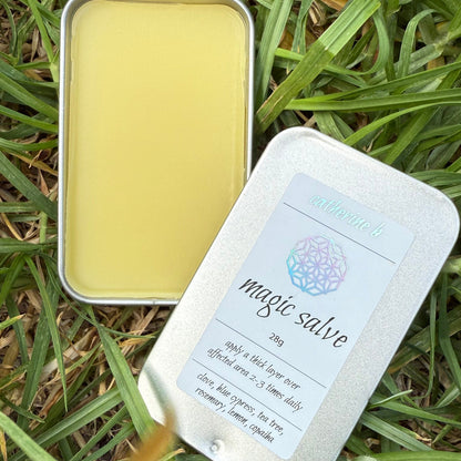 Metal tin with yellow magic salve and a label on grass