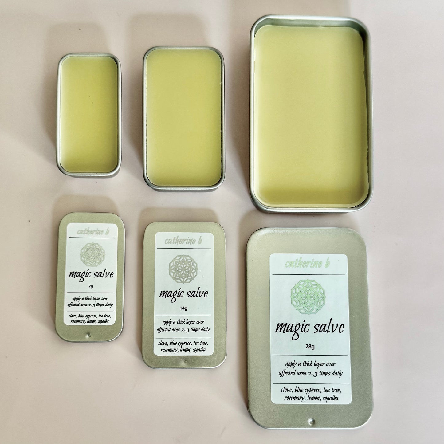 Collection of 'magic salve' tins with labels on a light background